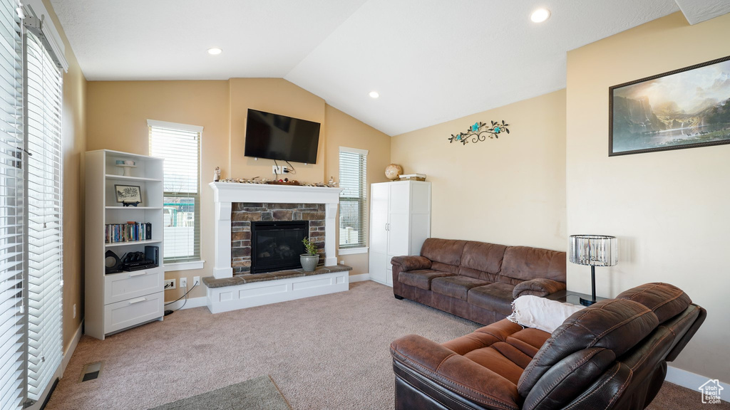 Living area with carpet, a fireplace, vaulted ceiling, recessed lighting, and baseboards