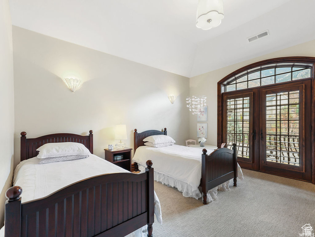 Bedroom featuring carpet floors, access to exterior, vaulted ceiling, and visible vents