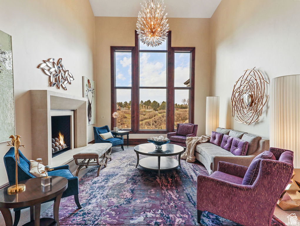 Living room featuring a lit fireplace and an inviting chandelier