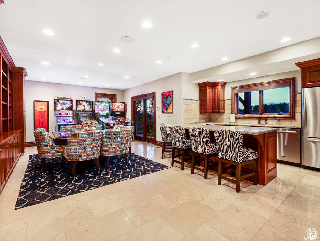 Dining area featuring baseboards, a healthy amount of sunlight, and recessed lighting