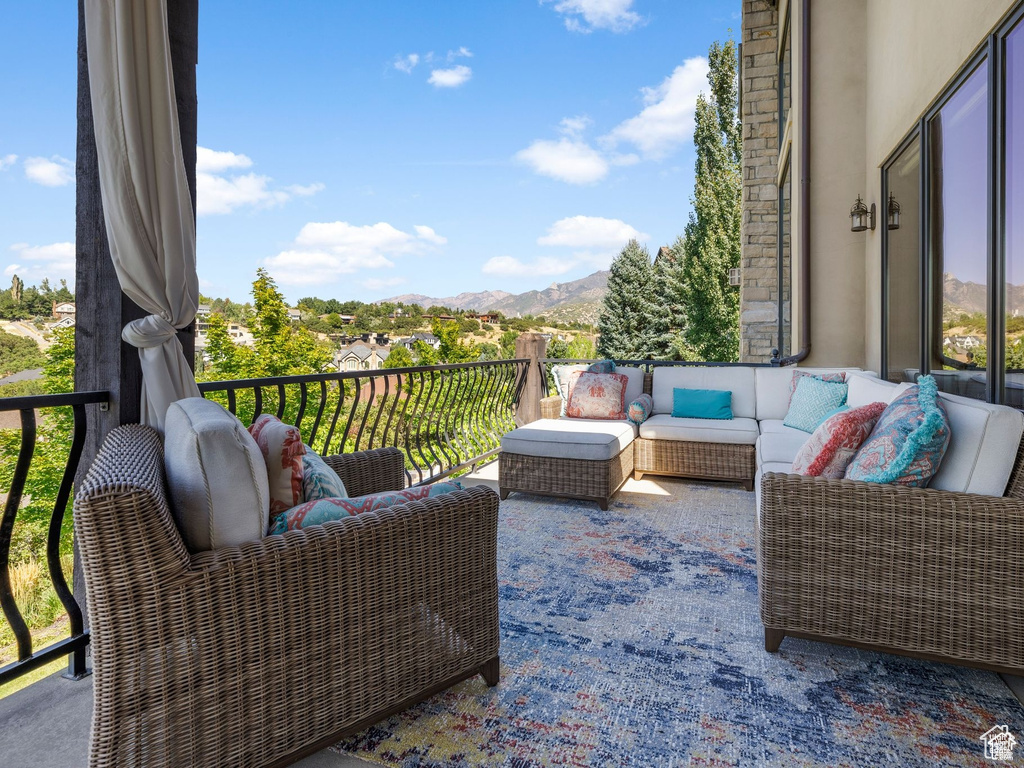 Exterior space featuring a balcony, an outdoor hangout area, and a mountain view