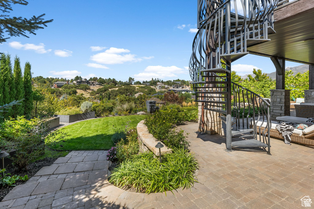 View of yard featuring stairs and a patio area