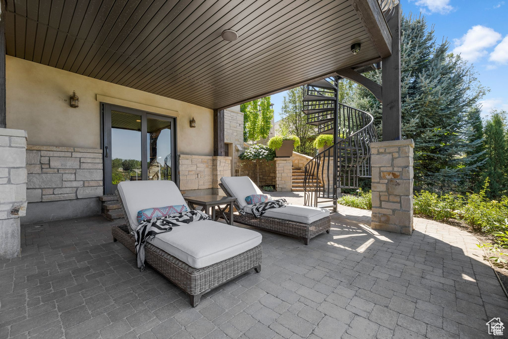 View of patio featuring stairway