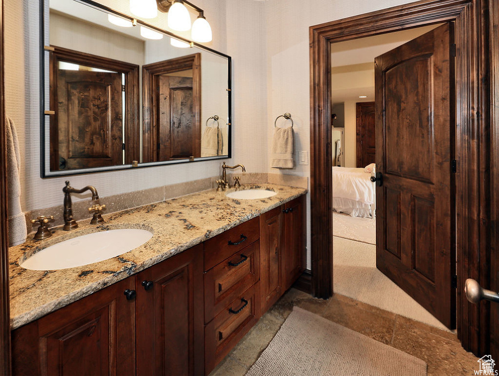 Ensuite bathroom with ensuite bath, a sink, and double vanity