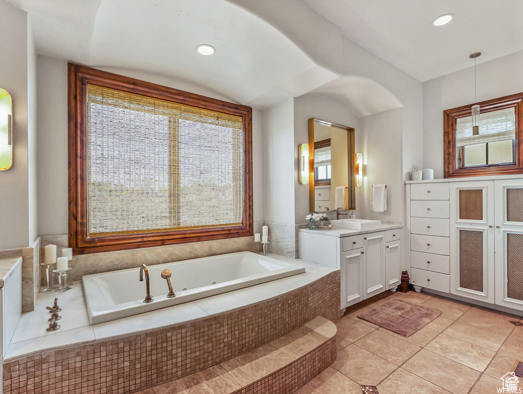 Bathroom with recessed lighting, a garden tub, tile patterned flooring, and vanity