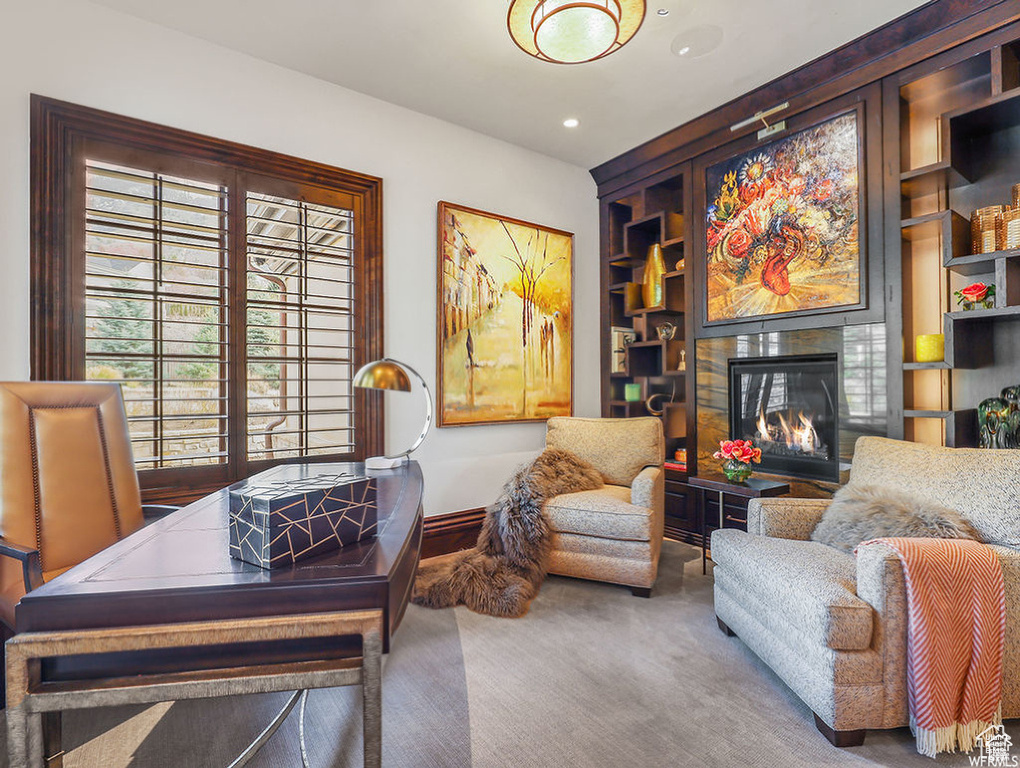 Interior space featuring baseboards, a fireplace, recessed lighting, and built in shelves