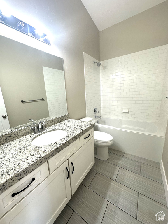 Bathroom featuring toilet, shower / washtub combination, and vanity