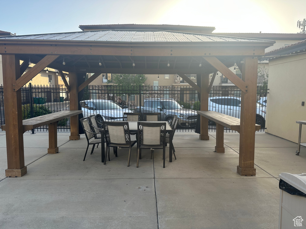 View of patio / terrace featuring a gazebo, fence, and outdoor dining space