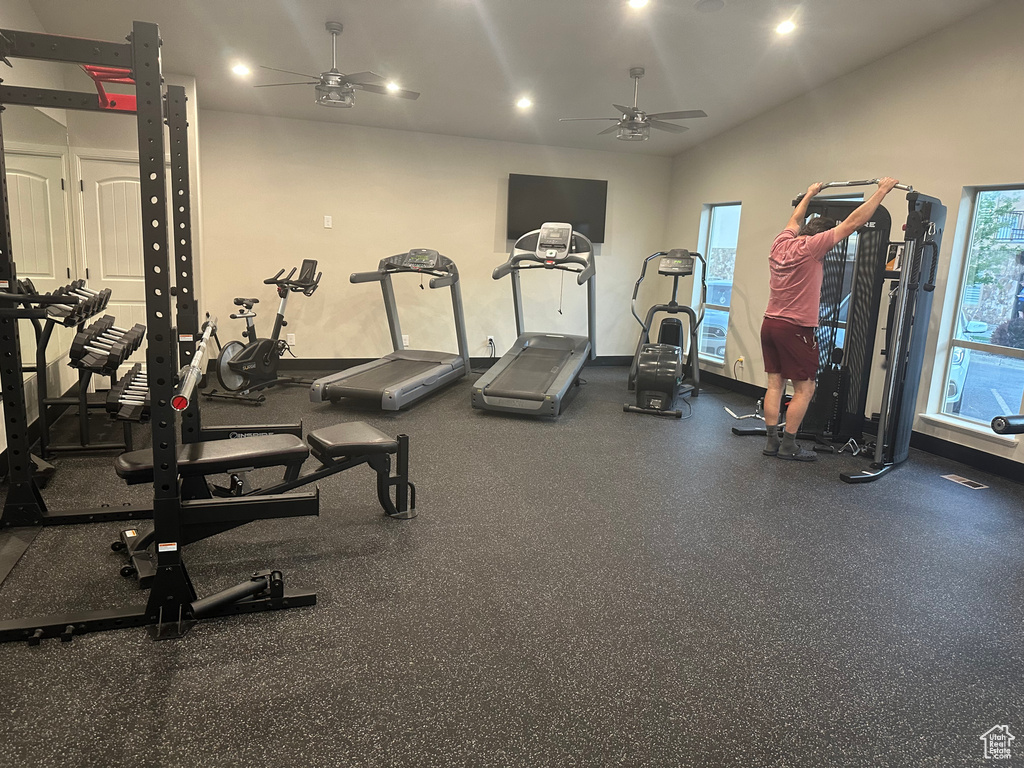 Exercise room featuring ceiling fan, healthy amount of natural light, lofted ceiling, and recessed lighting