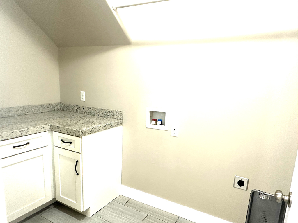 Laundry area featuring hookup for a washing machine, hookup for an electric dryer, and baseboards