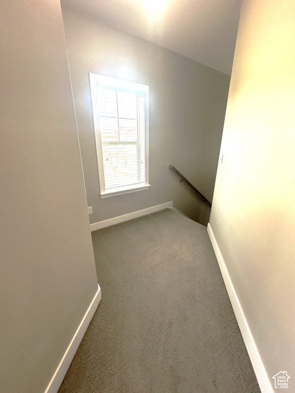 Empty room with carpet flooring and baseboards