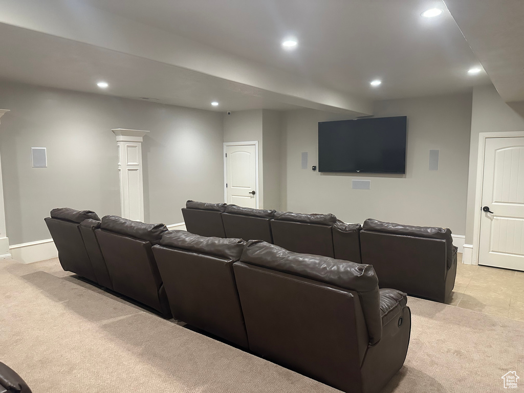 Home theater with recessed lighting, light colored carpet, and baseboards