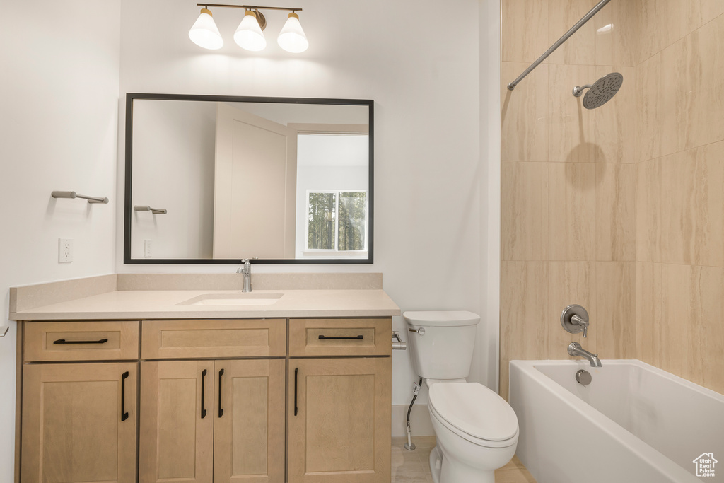 Bathroom featuring vanity, toilet, and shower / bath combination