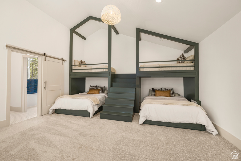 Bedroom with carpet flooring, high vaulted ceiling, and baseboards