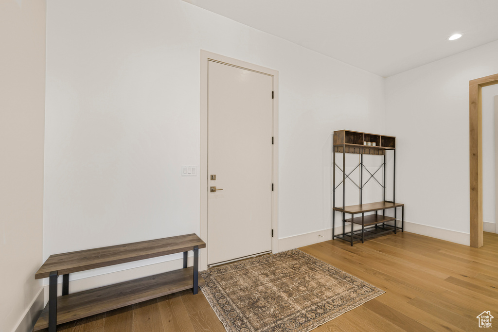 Foyer entrance featuring wood finished floors, recessed lighting, and baseboards