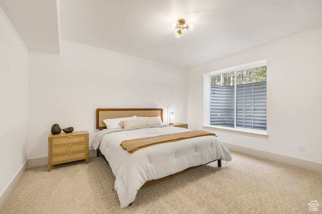 Carpeted bedroom featuring baseboards