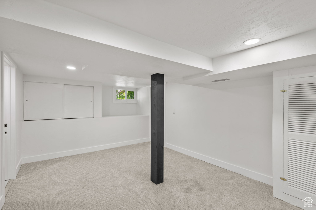 Basement with carpet flooring, baseboards, and recessed lighting