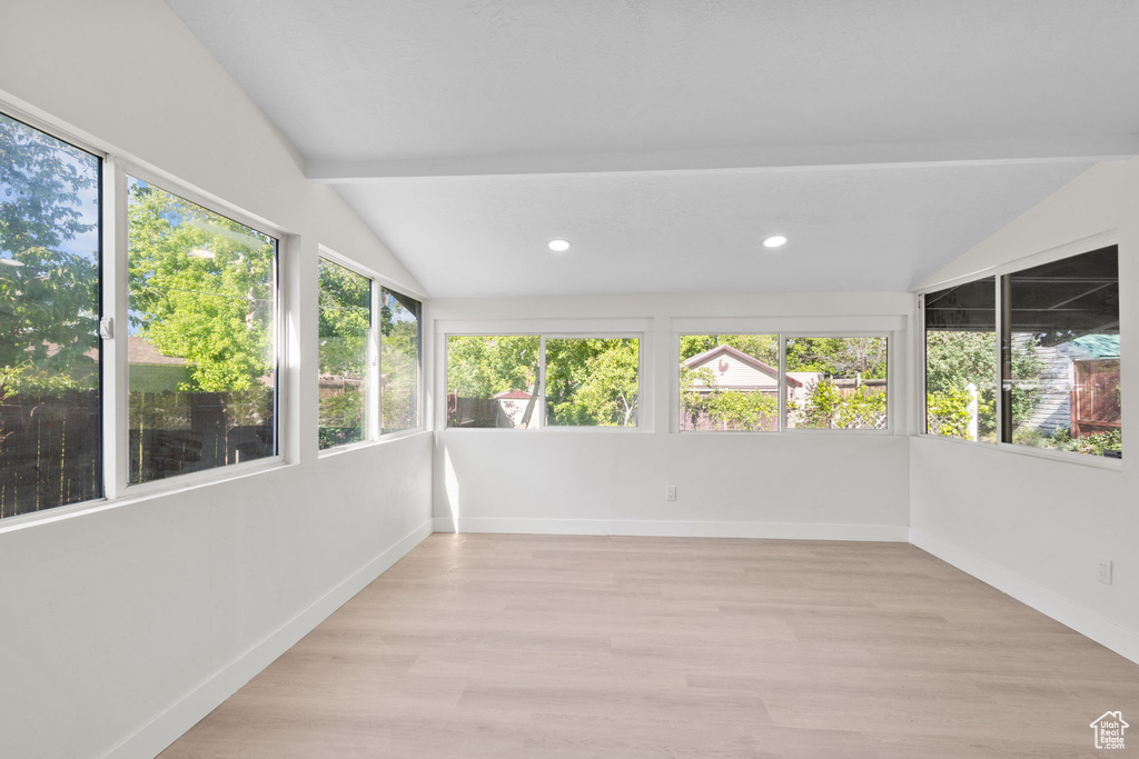 Unfurnished sunroom featuring healthy amount of natural light, wood finished floors, recessed lighting, and baseboards