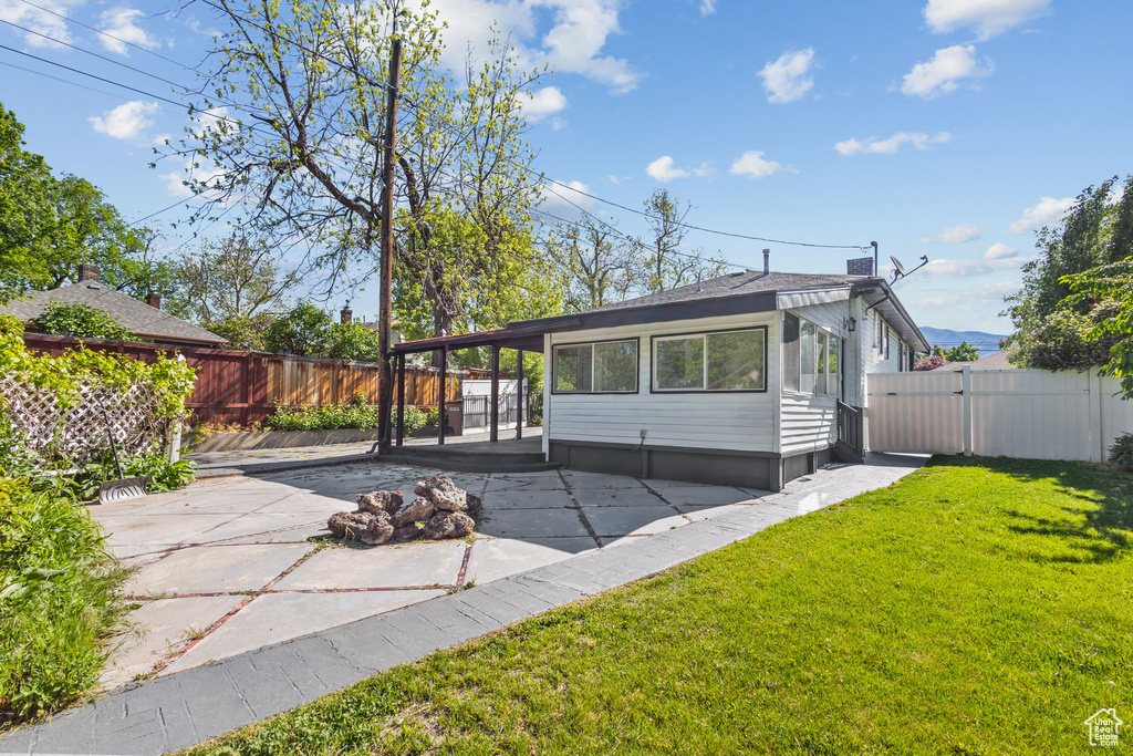 Back of property with a patio and a gate