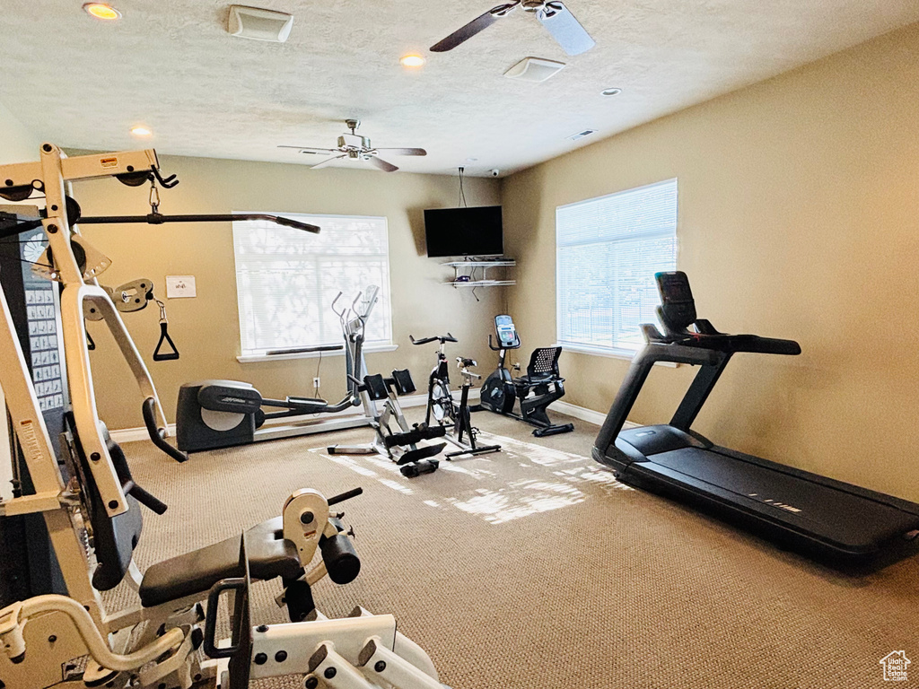 Exercise room featuring baseboards, a ceiling fan, recessed lighting, carpet floors, and a textured ceiling