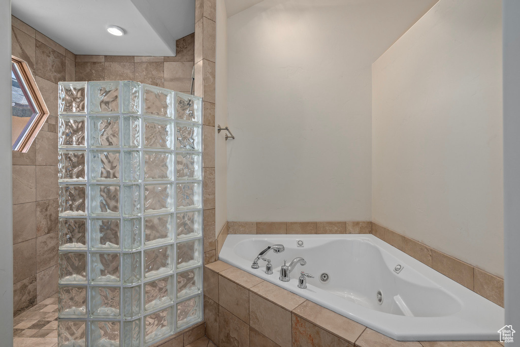 Bathroom with walk in shower and a whirlpool tub