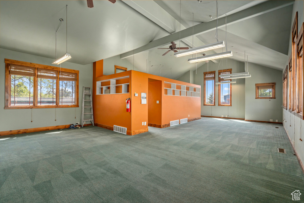 Carpeted empty room with ceiling fan and baseboards