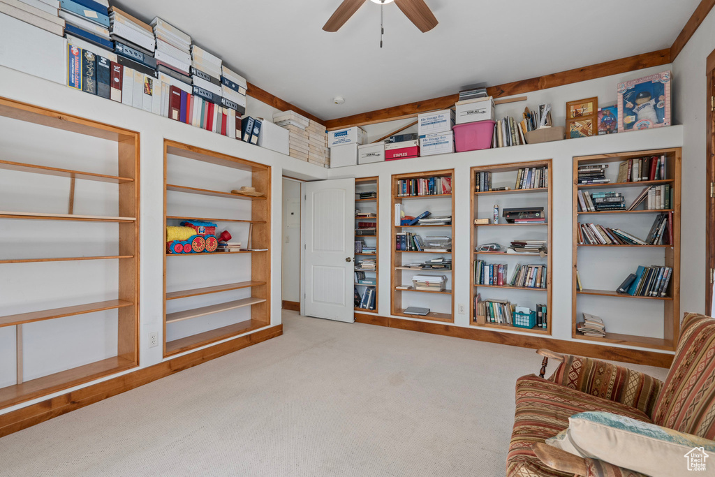 Living area with carpet and ceiling fan