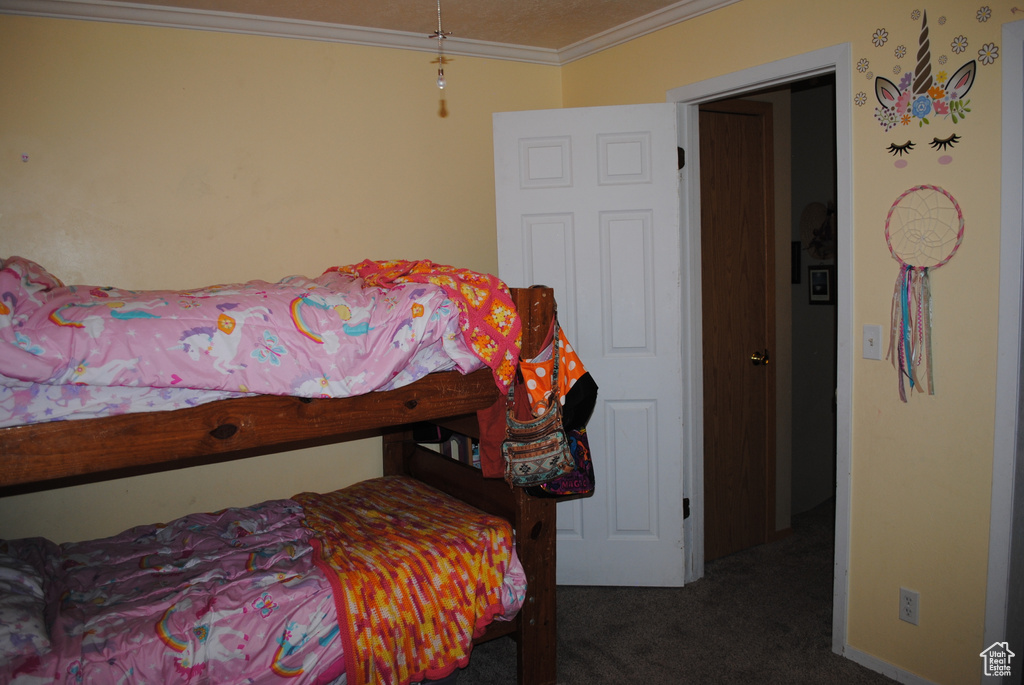 Carpeted bedroom featuring crown molding