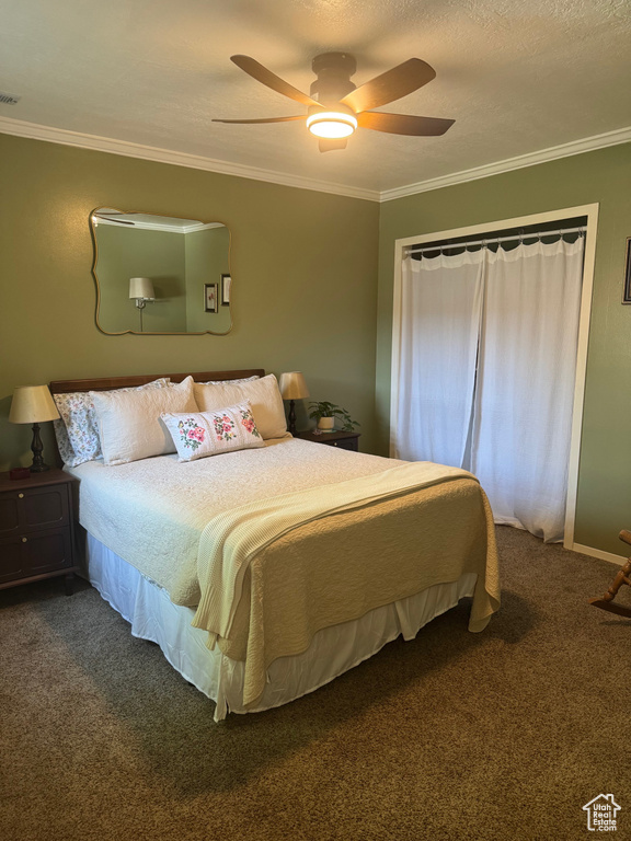 Carpeted bedroom featuring crown molding and a ceiling fan