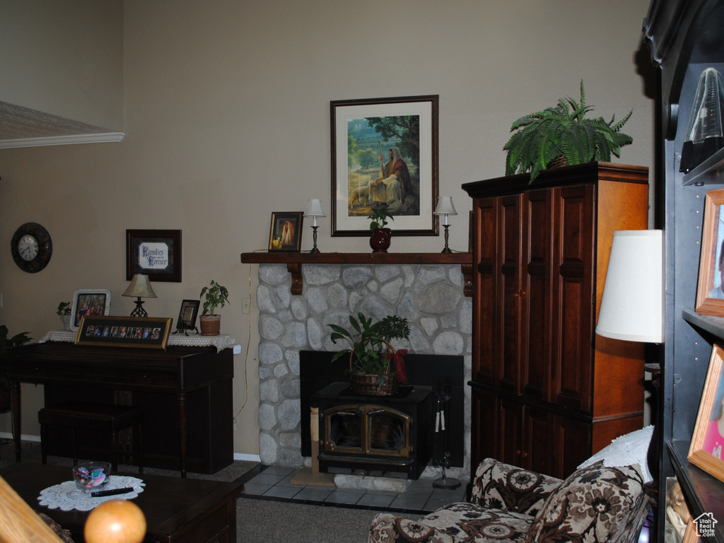 Living area featuring a wood stove and ornamental molding