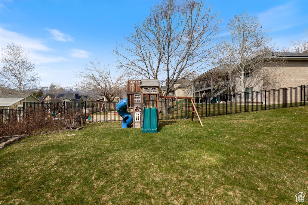View of yard with a playground and a residential view