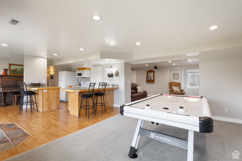 Game room with recessed lighting, light wood-style flooring, and baseboards