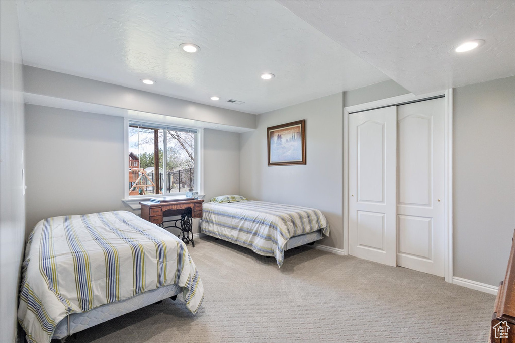Bedroom featuring carpet floors, recessed lighting, a closet, and baseboards
