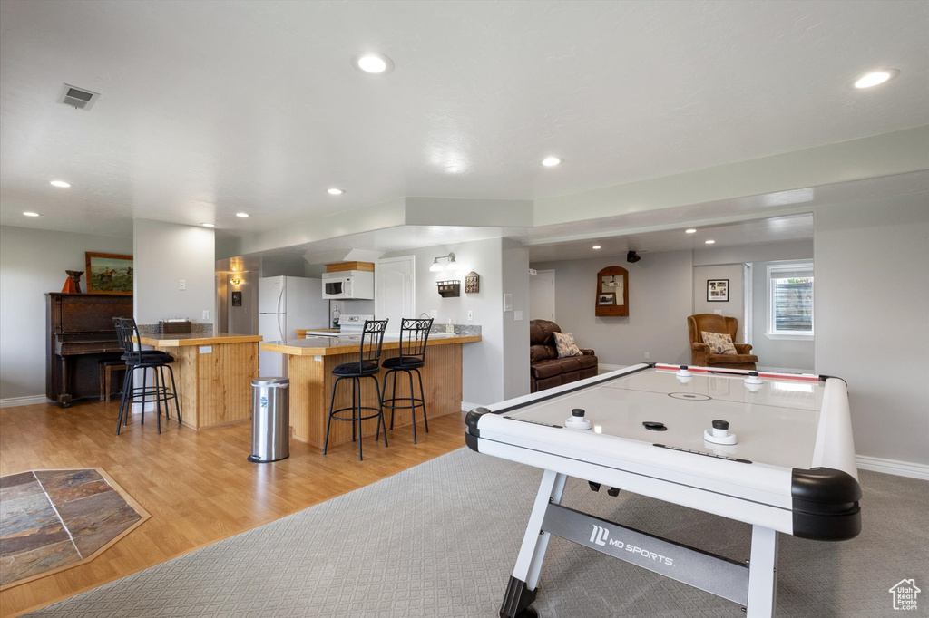 Game room featuring recessed lighting, light wood-type flooring, and baseboards