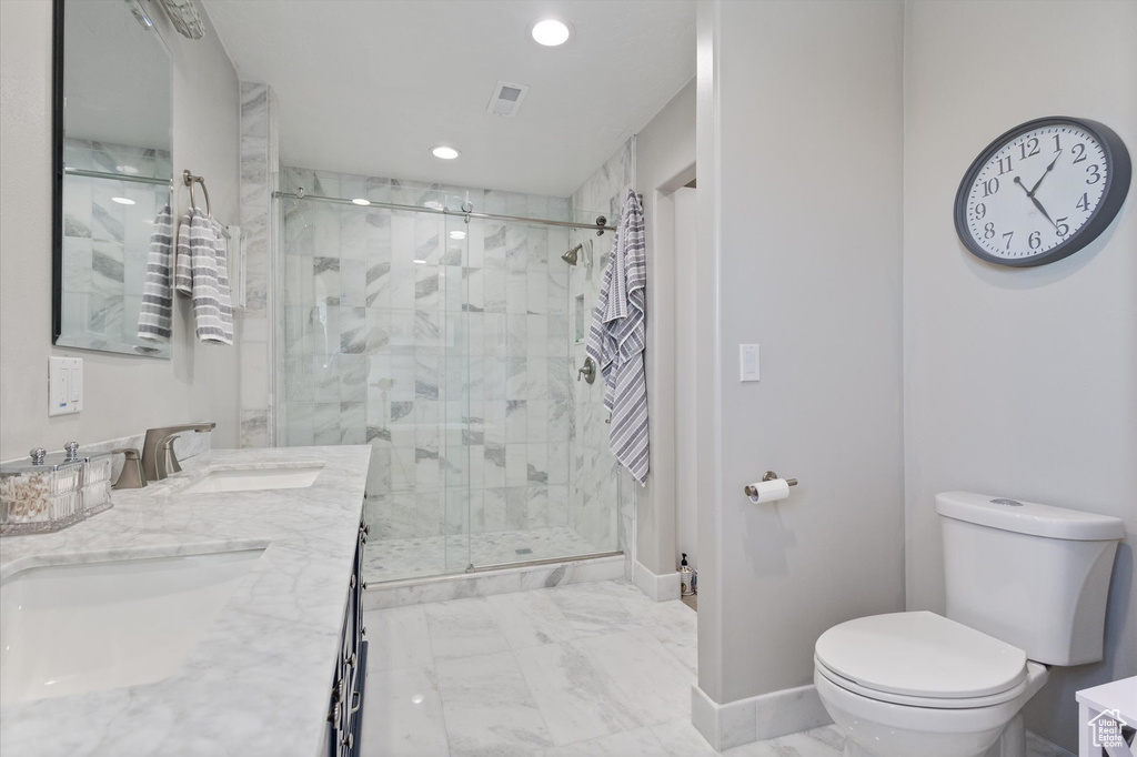 Bathroom with toilet, marble finish floors, a stall shower, recessed lighting, and baseboards