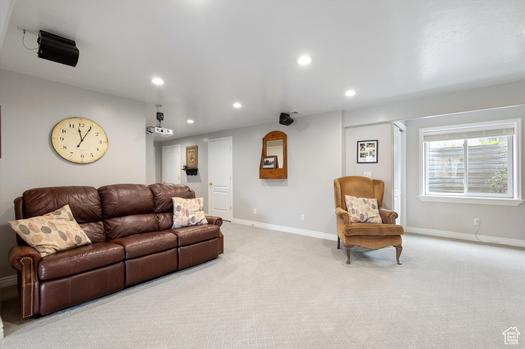 Living area with recessed lighting, baseboards, and carpet