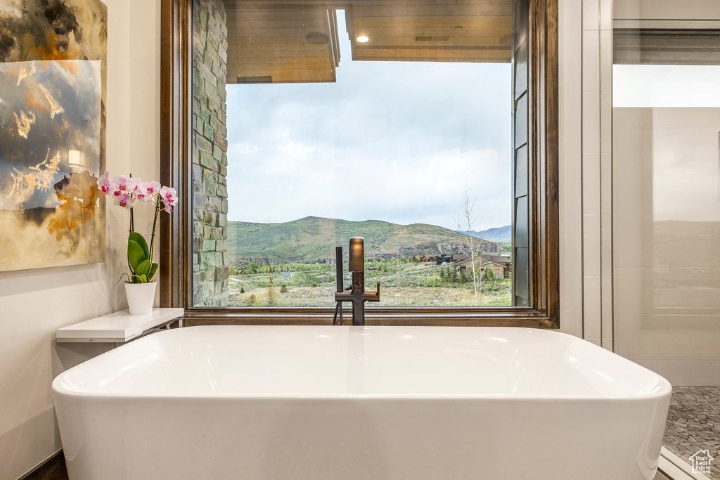 Bathroom featuring a mountain view and a soaking tub