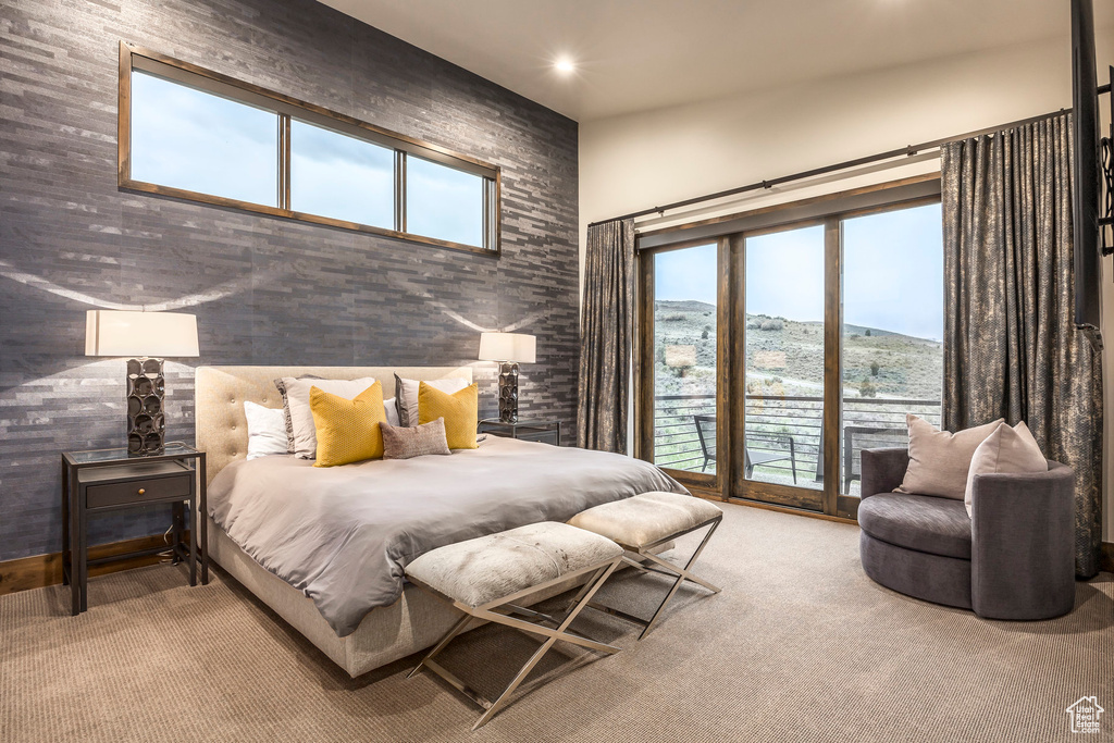 Carpeted bedroom featuring recessed lighting, access to exterior, and a towering ceiling