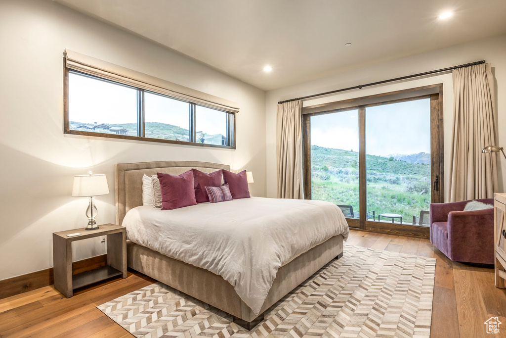 Bedroom with wood-type flooring and recessed lighting