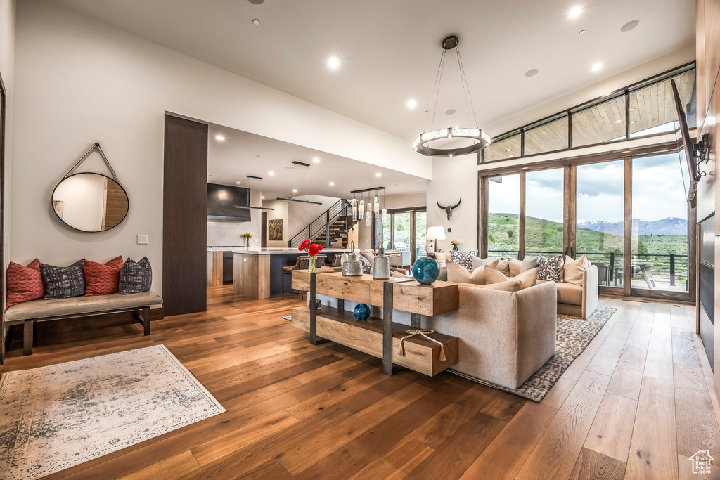 Living area featuring stairway, hardwood / wood-style flooring, and recessed lighting