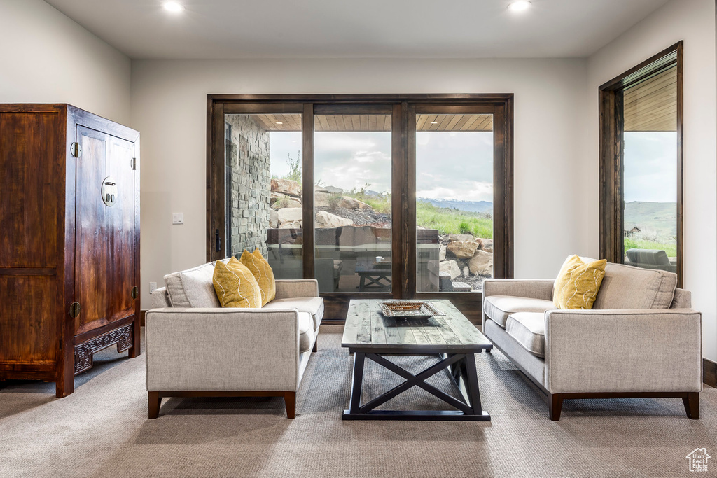 Carpeted living room with recessed lighting