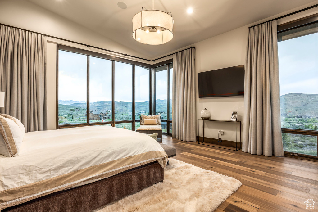 Bedroom featuring wood-type flooring and lofted ceiling