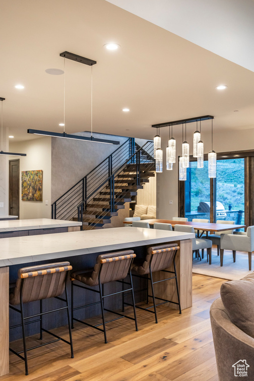 Dining area featuring light wood-style flooring, stairway, and recessed lighting