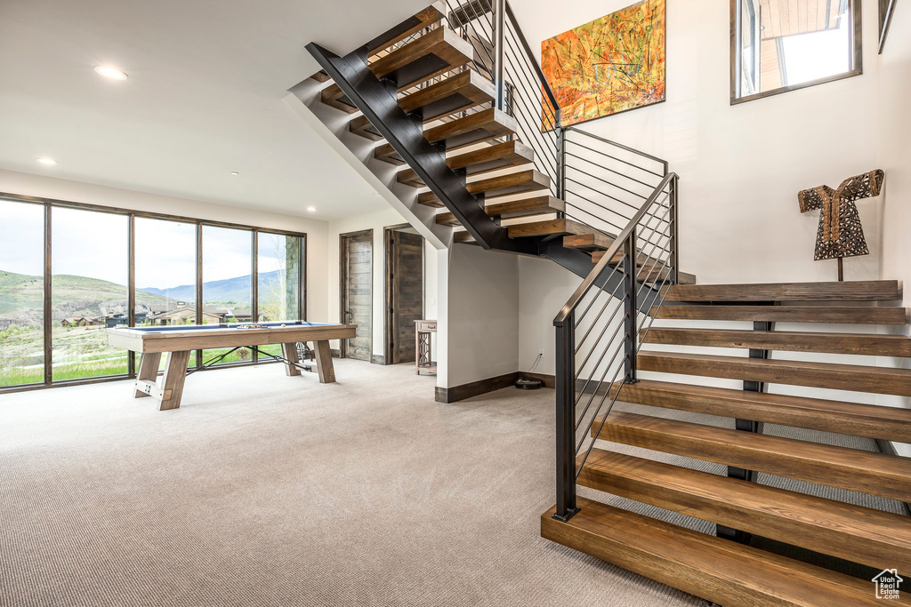 Staircase with carpet, pool table, recessed lighting, a mountain view, and baseboards