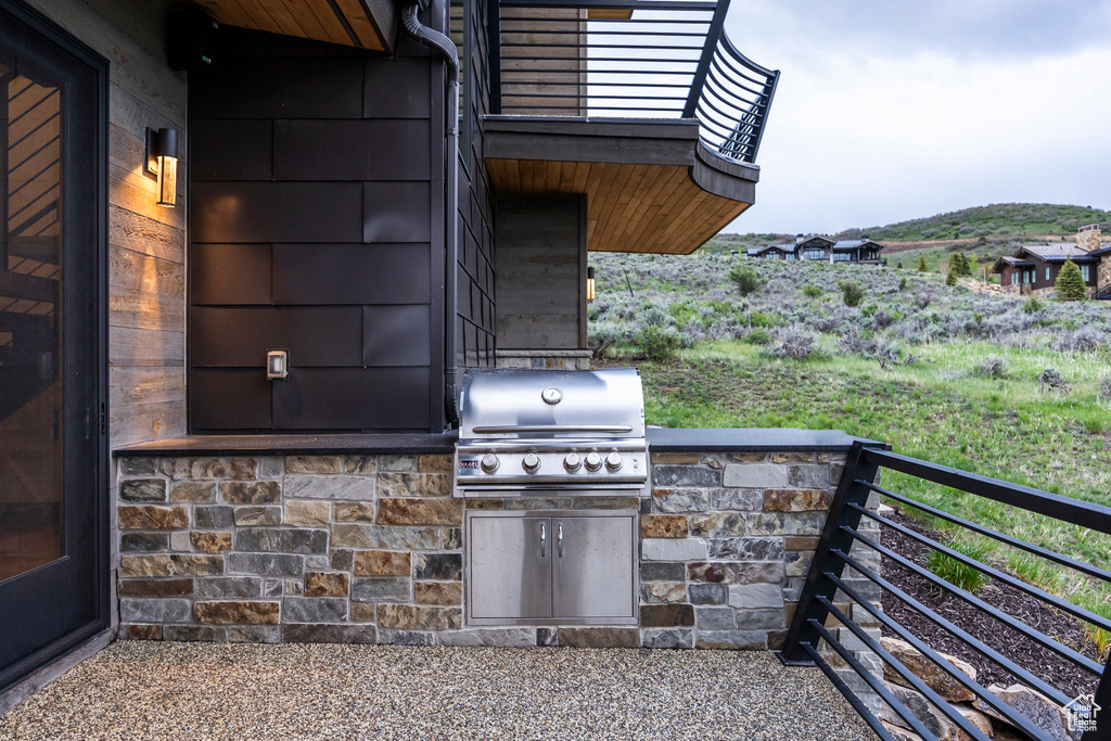 View of patio / terrace with grilling area and a balcony