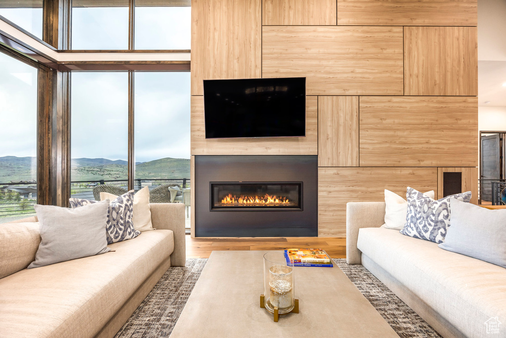 Living area featuring a mountain view, a large fireplace, and wood finished floors
