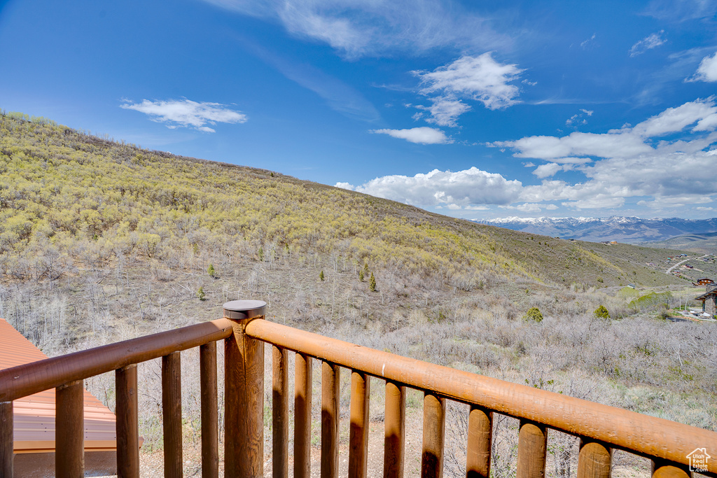 View of yard featuring a mountain view and a balcony