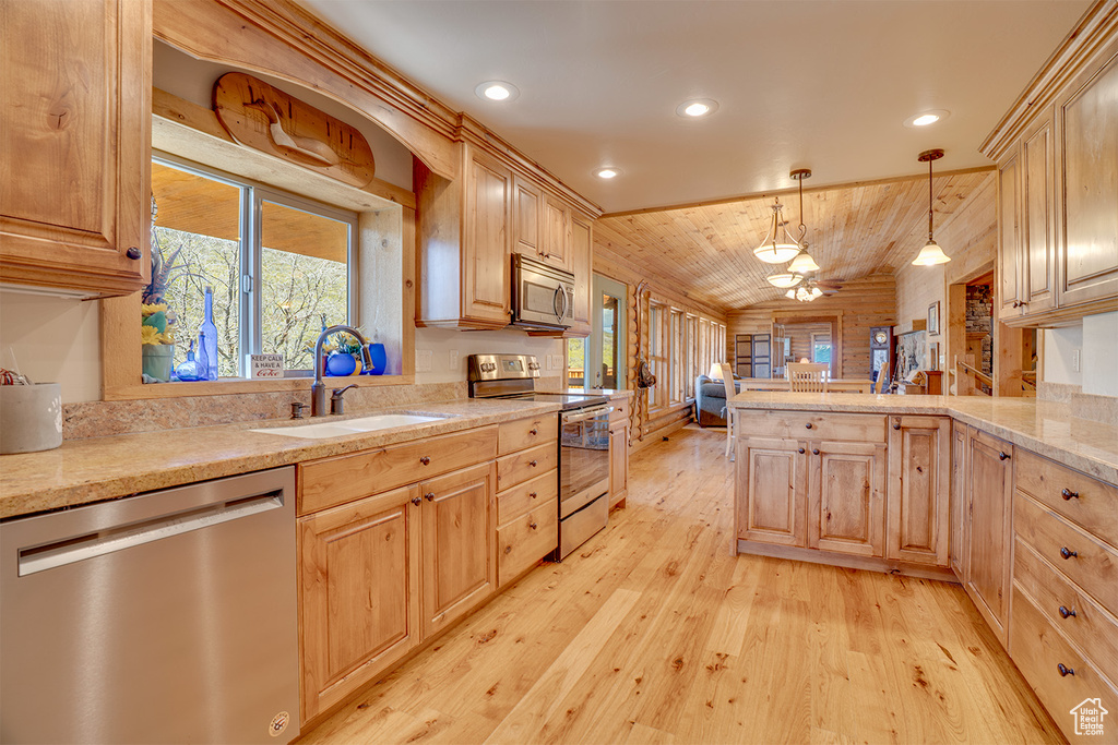 Kitchen with stainless steel appliances, a sink, light wood finished floors, light brown cabinetry, and wooden ceiling
