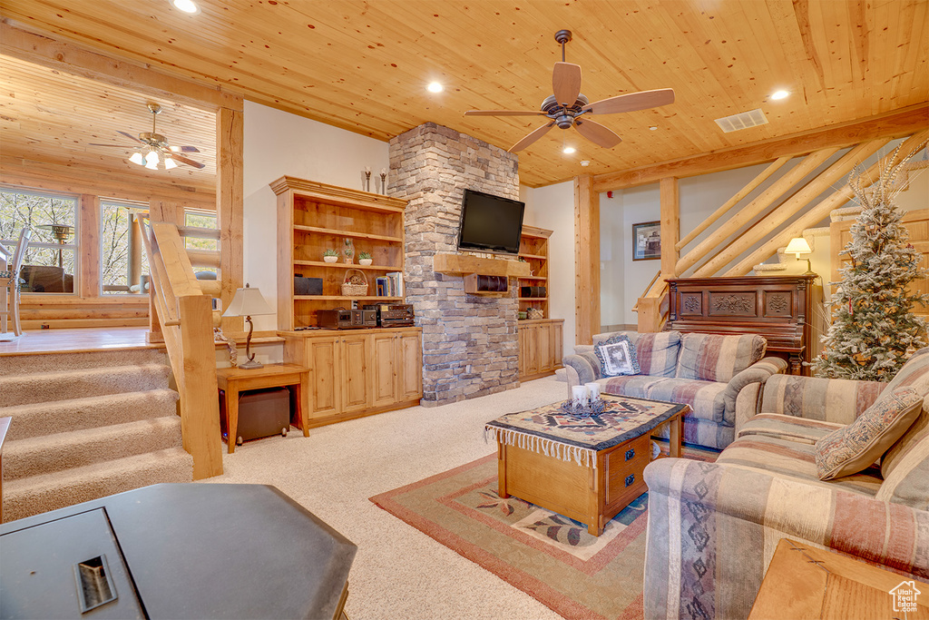 Living room featuring ceiling fan, wooden ceiling, stairs, carpet, and recessed lighting