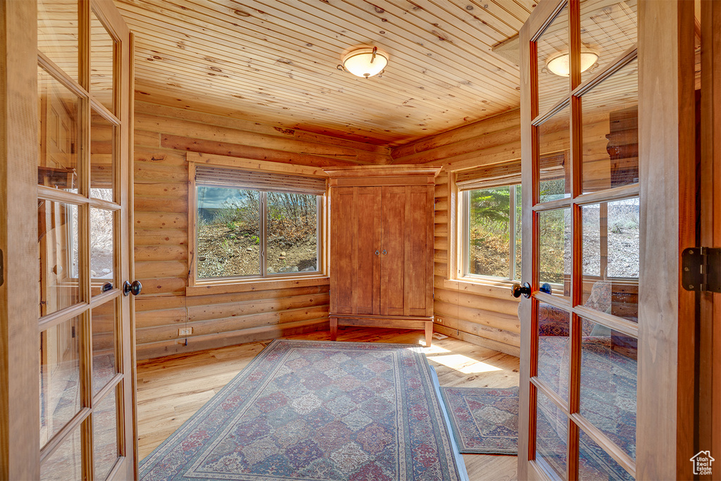Unfurnished sunroom featuring french doors and healthy amount of natural light